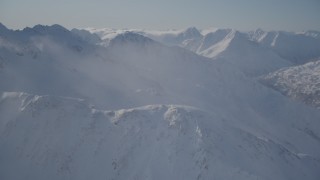 4K aerial stock footage snow covered mountain ranges and low clouds in Chugach Mountains, Alaska Aerial Stock Footage | AK0001_1930