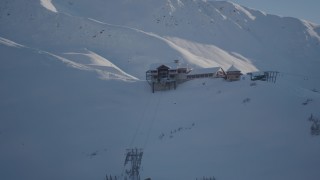 4K aerial stock footage orbiting a snow covered ski lodge at the summit, Girdwood, Alaska Aerial Stock Footage | AK0001_1964