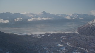 4K aerial stock footage the snow covered Kenai Mountains with low cloud cover, Girdwood, Alaska Aerial Stock Footage | AK0001_1969