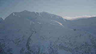 4K aerial stock footage flying away from a snow covered mountain peak, Girdwood, Alaska Aerial Stock Footage | AK0001_1970