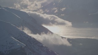 4K aerial stock footage low clouds around snow covered Chugach  and Kenai Mountains, Alaska Aerial Stock Footage | AK0001_1982