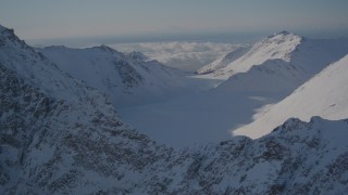 4K aerial stock footage the snow covered Chugach Mountains and low clouds, Alaska Aerial Stock Footage | AK0001_1989