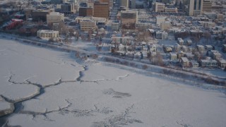 4K aerial stock footage tilt up from Knik Arm of the Cook Inlet to snowy Downtown Anchorage, Alaska Aerial Stock Footage | AK0001_2018