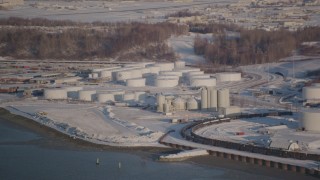 4K aerial stock footage flying away from a snow covered oil refinery in Anchorage, Alaska Aerial Stock Footage | AK0001_2031