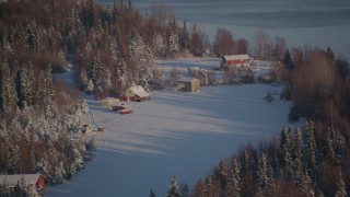 4K aerial stock footage cabins in snowy woods in Point MacKenzie, Alaska Aerial Stock Footage | AK0001_2034