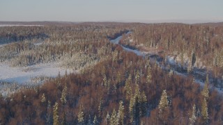 AK0001_2048 - 4K aerial stock footage flying toward a deserted, snowy rural highway in Point MacKenzie, Alaska