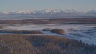 4K aerial stock footage snowy Chugach Mountains, woods, Big Lake Area, Knik-Fairview, Alaska Aerial Stock Footage | AK0001_2059