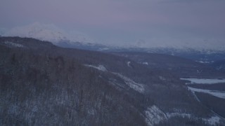 4K aerial stock footage snowy, forested hills, Matanuska River Valley, Chugach Mountains, Alaska, twilight  Aerial Stock Footage | AK0001_2112