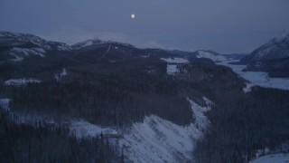 4K aerial stock footage reveal moon over snow covered Talkeetna Mountains at twilight, Sutton, Alaska Aerial Stock Footage | AK0001_2120