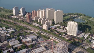 4.8K aerial stock footage tilt from train tracks, revealing Hyde Park apartment buildings, Chicago, Illinois Aerial Stock Footage | AX0001_011