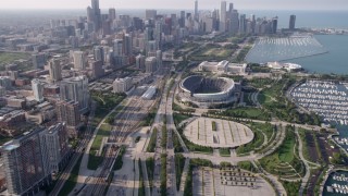 AX0001_020 - 4.8K aerial stock footage tilt from Highway 41 to reveal Soldier Field and Downtown Chicago skyline, on a hazy day, Illinois