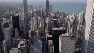 AX0001_026 - 4.8K aerial stock footage of The Jay Pritzker Pavilion, revealing Downtown Chicago skyscrapers, on a hazy day, Illinois