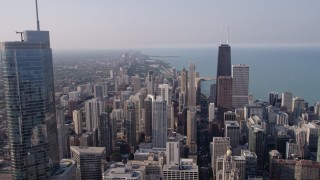 4.8K aerial stock footage flying past Trump International toward John Hancock Center in Downtown Chicago, Illinois, on a hazy day Aerial Stock Footage | AX0001_028