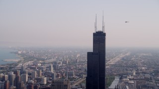 4.8K aerial stock footage orbiting the top of the Willis Tower on a hazy day, Chicago, Illinois Aerial Stock Footage | AX0001_043