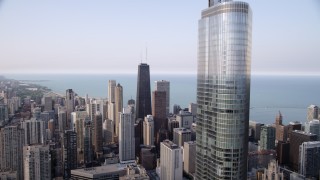 AX0001_049 - 4.8K aerial stock footage flyby Trump Tower Chicago with a view across downtown at John Hancock Center, Downtown Chicago, Illinois