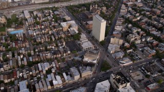 4.8K aerial stock footage tilt from streets in West Chicago, revealing the freeway and skyline, on a hazy day, Downtown Chicago, Illinois Aerial Stock Footage | AX0001_062