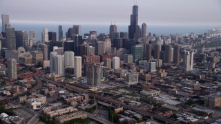 AX0001_065 - 4.8K aerial stock footage tilting up from heavy traffic on Interstate 90 and 94, revealing Downtown Chicago skyscrapers, Illinois