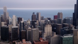 4.8K aerial stock footage panning across Downtown Chicago on a hazy day to reveal Willis Tower, Illinois Aerial Stock Footage | AX0001_068