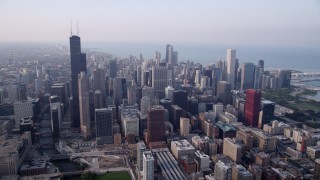 4.8K aerial stock footage approach Willis Tower and Downtown Chicago buildings on a hazy day, Illinois Aerial Stock Footage | AX0001_079