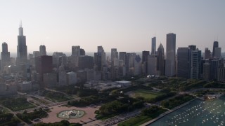 4.8K aerial stock footage video tilt from Lake Michigan, revealing the harbor, Grant Park, and Downtown Chicago skyline, Illinois Aerial Stock Footage | AX0001_101