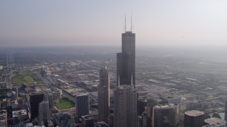 4.8K aerial stock footage flying by Willis Tower, hazy day, Downtown Chicago, Illinois Aerial Stock Footage | AX0001_107