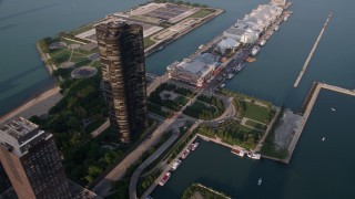 AX0001_120 - 4.8K aerial stock footage bird's eye of skyscraper, tilt to reveal Navy Pier, Downtown Chicago, Illinois