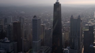 4.8K aerial stock footage flying toward John Hancock Center on a hazy day, Downtown Chicago, Illinois Aerial Stock Footage | AX0001_130