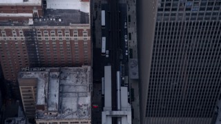 AX0001_147 - Aerial stock footage of 4.8K aerial  video of a Bird's eye view of L trains in and out of stations in Downtown Chicago, Illinois