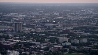 4.8K aerial stock footage of White Sox Stadium surrounded by the city scape on a hazy day, Chicago, Illinois Aerial Stock Footage | AX0001_155