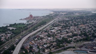 4.8K aerial stock footage of bird's eye of grain elevation, tilt up to Chicago Skyway and freeway, East Side Chicago, Illinois Aerial Stock Footage | AX0001_166