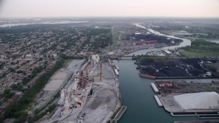 4.8K aerial stock footage following Calumet River toward bridge between lime plant and petroleum coke, East Side Chicago, Illinois Aerial Stock Footage | AX0001_168