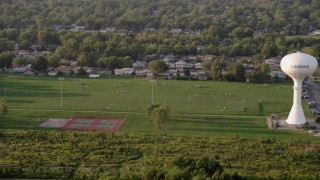 AX0001_178 - 4.8K aerial stock footage players playing football at Thornton Fractional South High School in Lansing, on a hazy day, Illinois