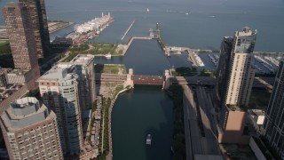 AX0002_042 - 4.8K aerial stock footage follow the river through downtown, tilt and approach Navy Pier and Lake Michigan, Downtown Chicago, Illinois