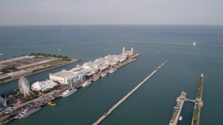 AX0002_043 - 4.8K aerial stock footage of flying out to Lake Michigan, and pan to Navy Pier in Chicago, Illinois