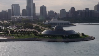 AX0002_087 - 4.8K aerial stock footage of a low altitude orbit of Adler Planetarium, Downtown Chicago, Illinois