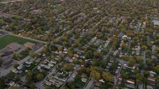 AX0003_002 - 4.8K aerial stock footage of flying by a Lansing residential neighborhood revealing Coolidge Elementary School, at sunset, Lansing, Illinois