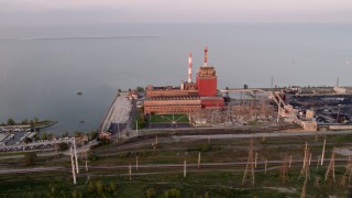 AX0003_011 - 4.8K aerial stock footage of orbiting the State Line Generating Plant on a hazy day, Hammond, Indiana