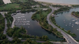 AX0003_017 - 4.8K aerial stock footage of flying over Jackson Park Harbor at twilight, Chicago, Illinois