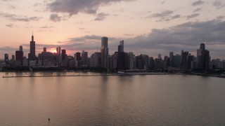 4.8K aerial stock footage of flying by the skyline from over Lake Michigan, Downtown Chicago, Illinois, sunset Aerial Stock Footage | AX0003_031