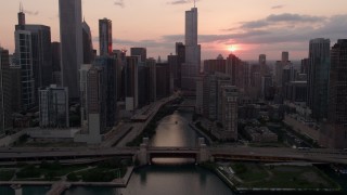 4.8K aerial stock footage approach and fly over the bridge at mouth of Chicago River at sunset, Downtown Chicago, Illinois Aerial Stock Footage | AX0003_035