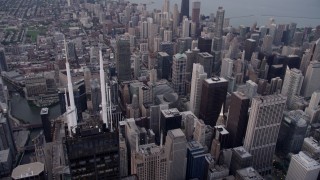 4.8K aerial stock footage of flying by Willis Tower spires, tilt down to Downtown Chicago buildings, Illinois, sunset Aerial Stock Footage | AX0003_046