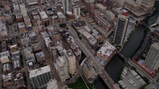 4.8K aerial stock footage tilt from the Chicago River to reveal and approach Downtown Chicago skyscrapers at sunset, Illinois Aerial Stock Footage | AX0003_058