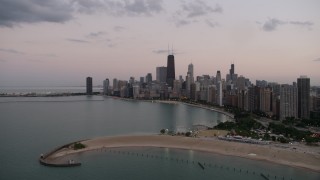 4.8K aerial stock footage approach North Avenue Beach and the skyline of Downtown Chicago, on a cloudy day at twilight, Illinois Aerial Stock Footage | AX0003_073