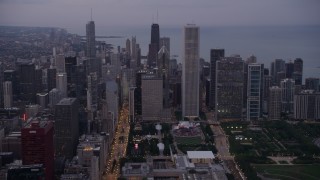 4.8K aerial stock footage tilt from Buckingham Fountain at Grant Park, revealing Downtown Chicago skyscrapers, on a hazy day at sunset, Illinois Aerial Stock Footage | AX0003_083