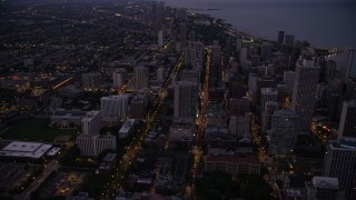 4.8K aerial stock footage tilt from N Clark Street and follow it north through Downtown Chicago, Illinois, twilight Aerial Stock Footage | AX0003_111