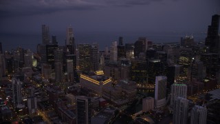 4.8K aerial stock footage of a view across Downtown Chicago at sunset, with Lake Michigan in the background at twilight, Illinois Aerial Stock Footage | AX0003_114