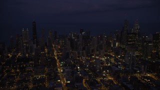 4.8K aerial stock footage of passing by Downtown Chicago cityscape at night, Illinois Aerial Stock Footage | AX0003_139