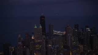 4.8K aerial stock footage of John Hancock Center as a helicopter flies by at night, Downtown Chicago, Illinois Aerial Stock Footage | AX0003_140