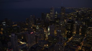 AX0003_143 - 4.8K aerial stock footage of flying over Downtown Chicago toward Aon Center and Trump International at night, Illinois