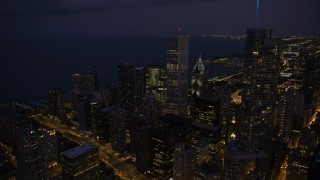 4.8K aerial stock footage of passing Trump Tower to approach Aon Center and Two Prudential Plaza in Downtown Chicago, at night, Illinois Aerial Stock Footage | AX0003_144